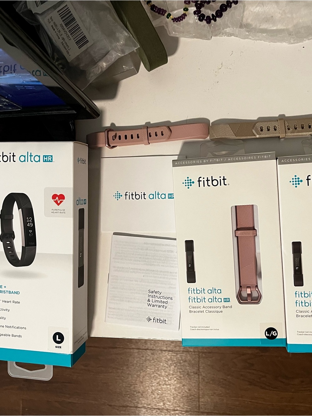Black used Fitbit Device plus replacement bands in rose pink and tan
